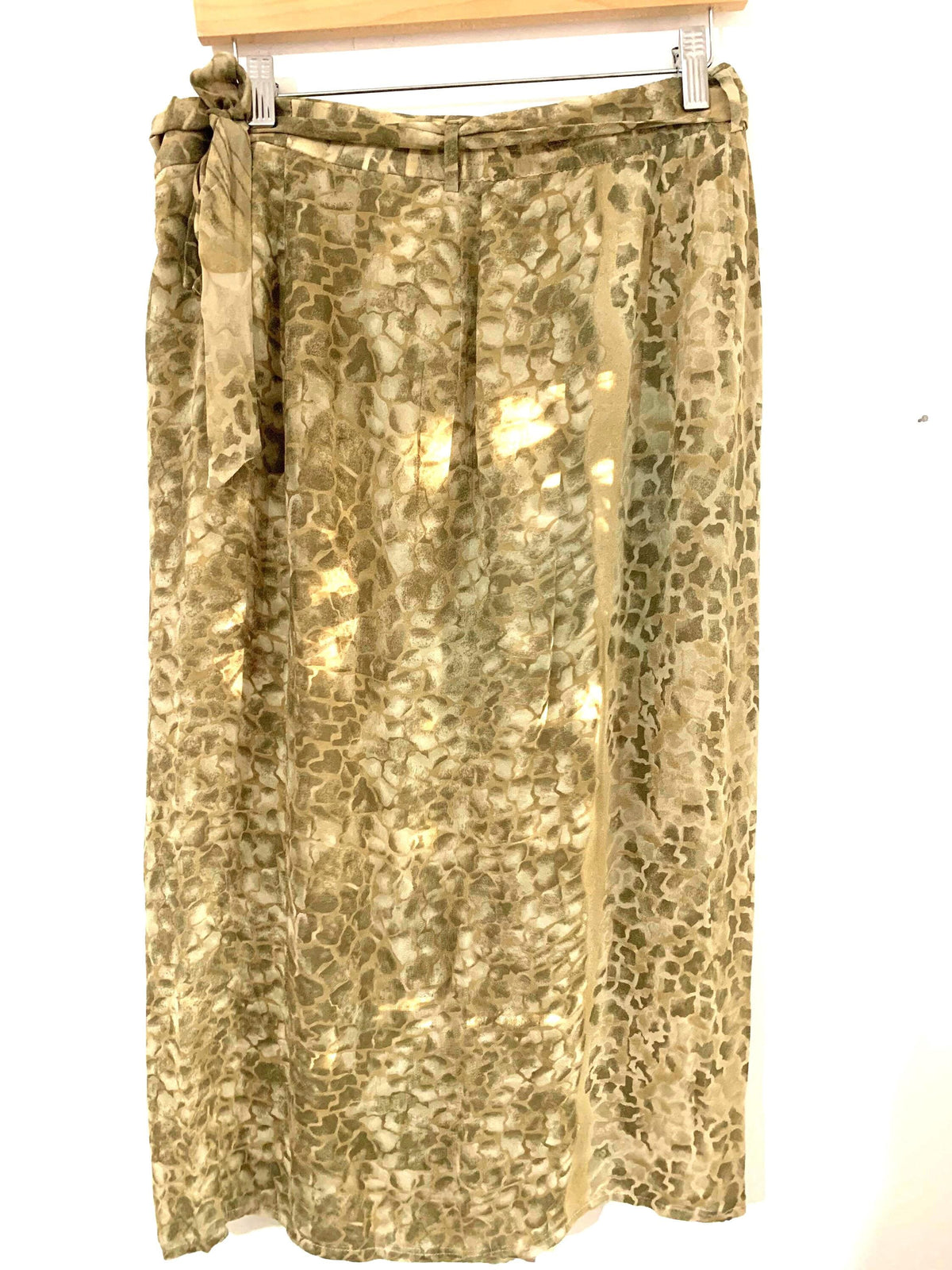 May include: A long green and brown patterned skirt with a tie at the waist.